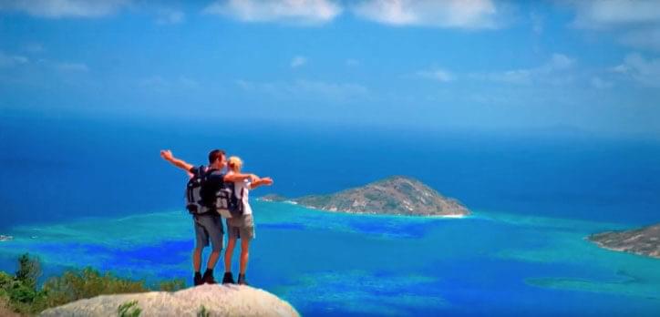 A couple looking over the ocean after a Cairns hike