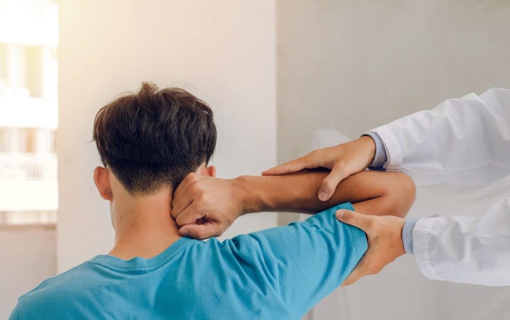 physiotherapist with a patient with a sports injury
